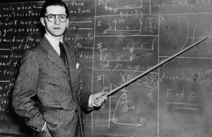 1930s Man Teacher Looking At Camera With Pointer At Blackboard