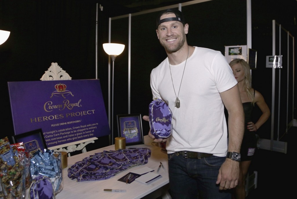 Musician Chase Rice stuffs a Crown Royal CAMO care package to be sent to troops backstage at the 2015 CMT Awards at Bridgestone Arena on June 10, 2015 in Nashville, Tennessee. (Photo by Anna Webber/Getty Images for Crown Royal) 